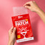 Hands pulling a sheet of CHEAL Recovery Patches out of the red pouch