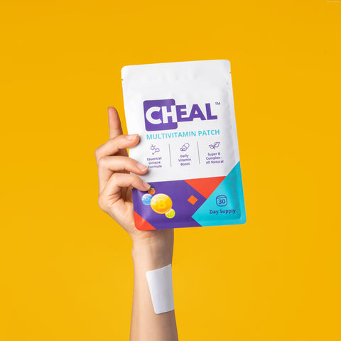 Hand holding up a CHEAL Multivitamin Patch pouch, with a white patch on the wrist